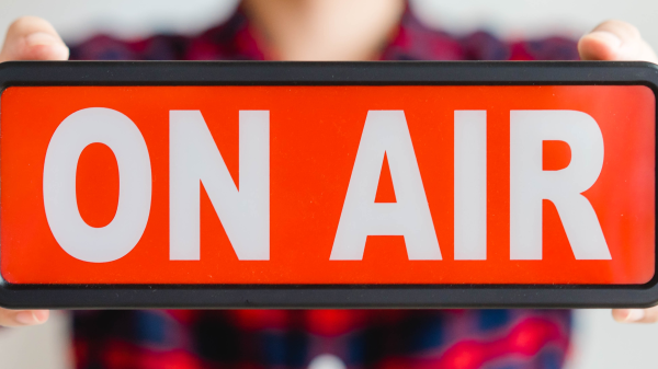 Mann hält ein On Air Schild in den Händen, © Shutterstock