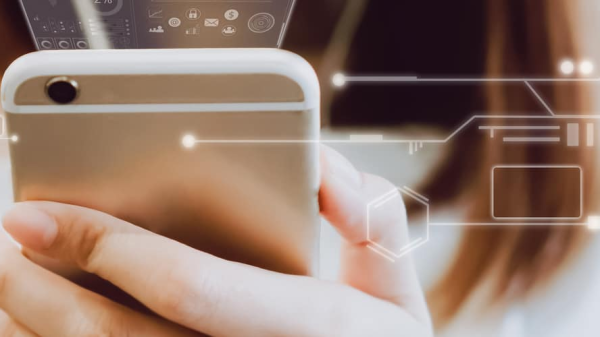 Handy im Vordergrund, Frau im Hintergrund, © Shutterstock